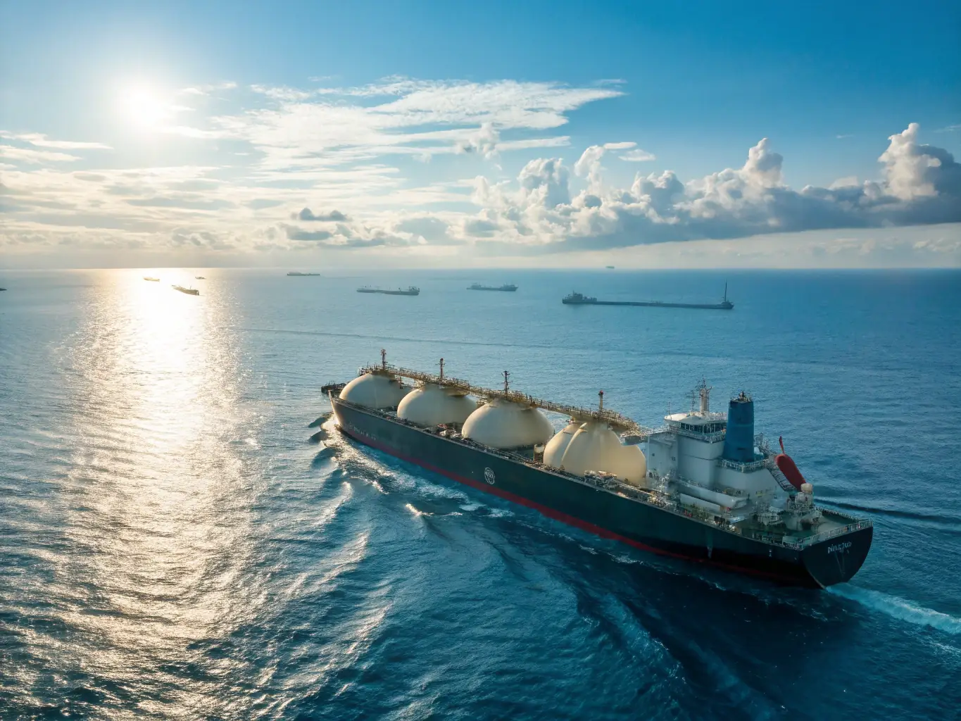 A wide shot of a large LNG tanker being loaded at a port facility, showcasing the scale and complexity of LNG transportation. The image should convey a sense of global reach and logistical expertise.